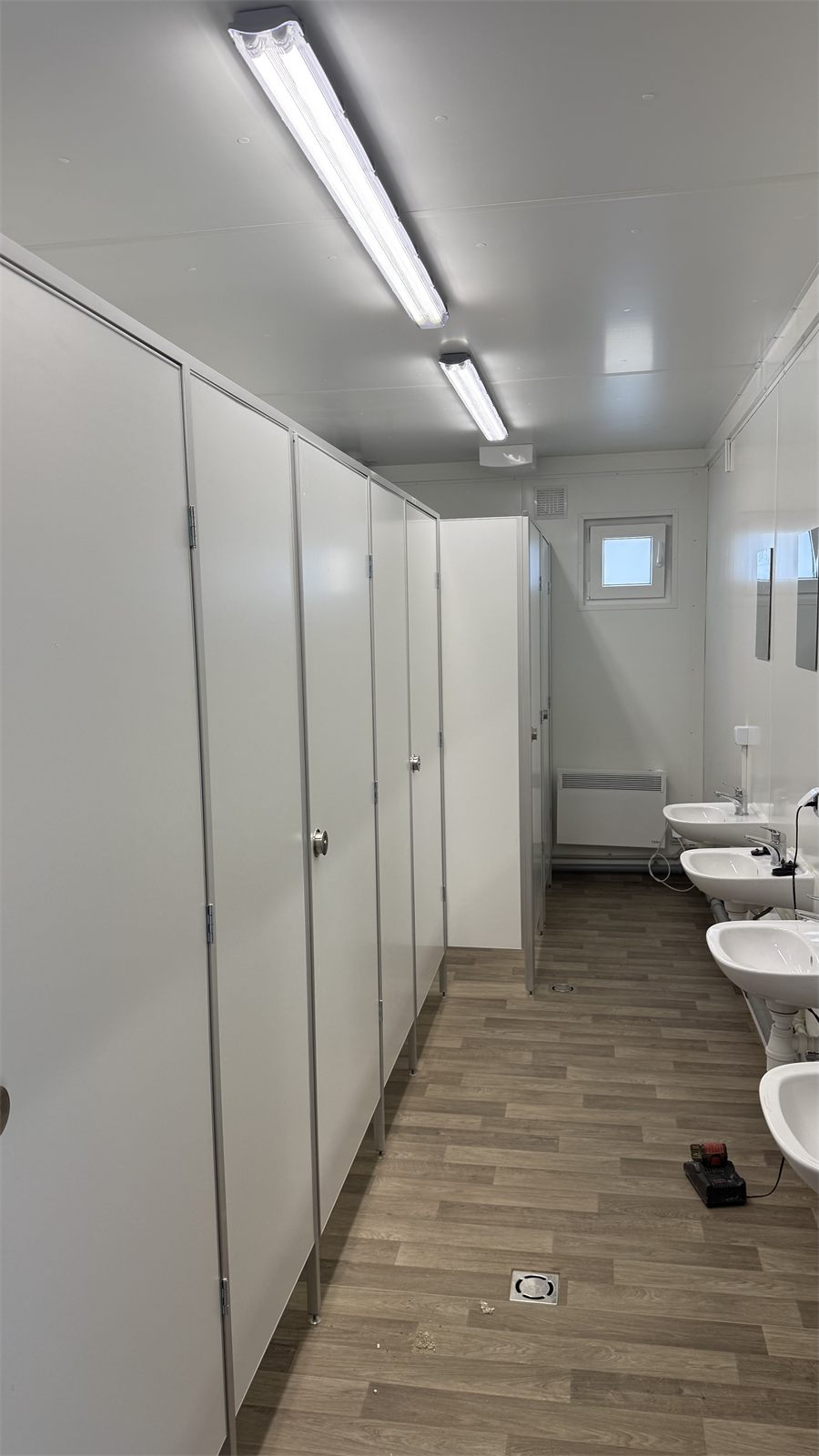 Sanitärbereich mit WC-Kabinen und Waschbecken